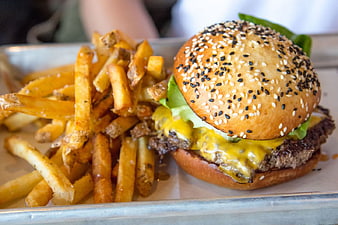 Cheeseburger with Sesame Bun and Crispy Fries on Tray