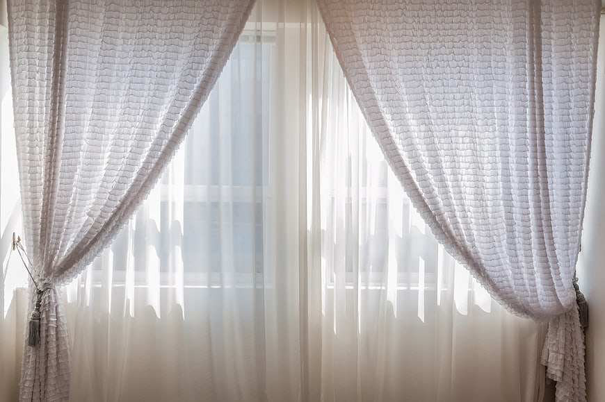White Sheer Curtains And Textured Drapes In Bright Window