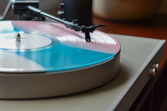 Close-up of a colorful vinyl record spinning on a turntable