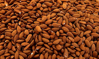 Close-up texture of roasted almonds filling the frame