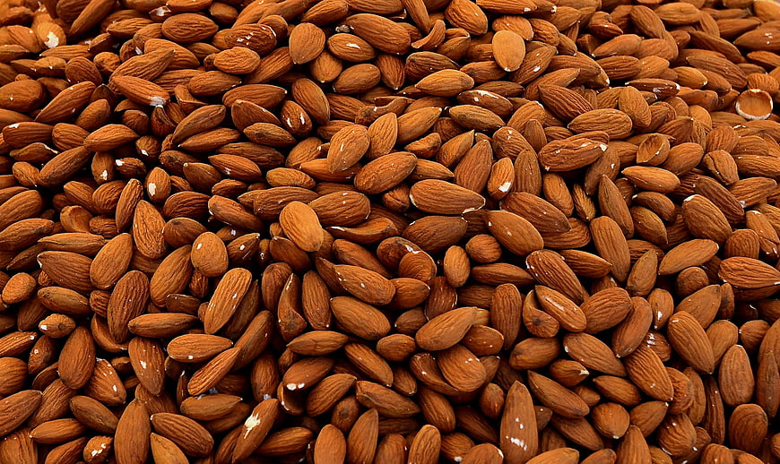 Close-up texture of roasted almonds filling the frame