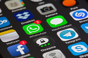 Close-up of smartphone screen displaying WhatsApp, Facebook, and other app icons