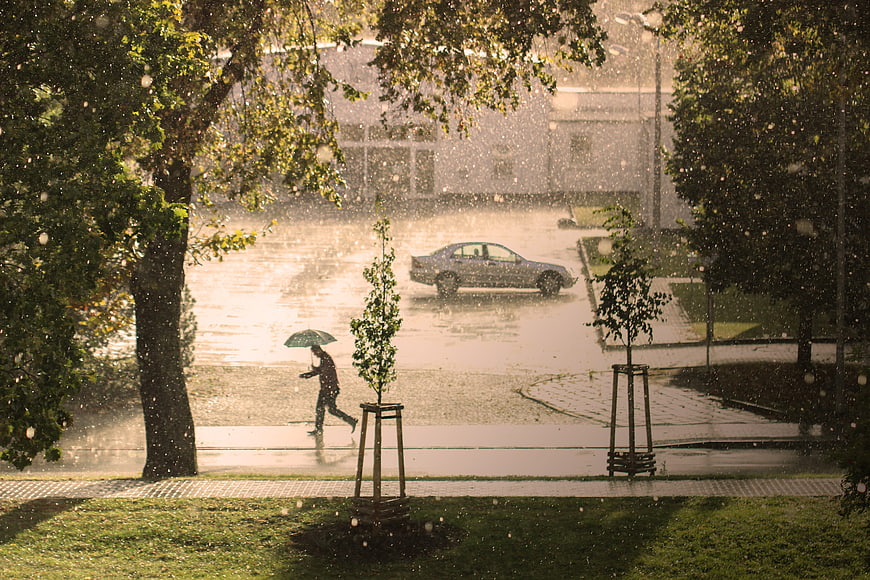 Man Running With Umbrella In Heavy Rainstorm