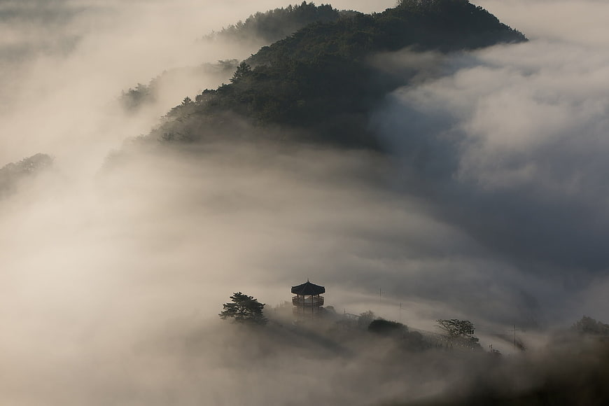 Traditional Korean Pavilion Surrounded by Thick Mountain Fog