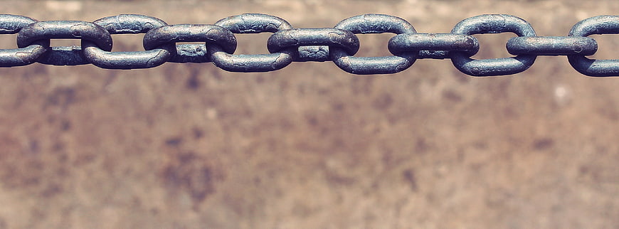 Rusty metal chain links with large blurred background copyspace