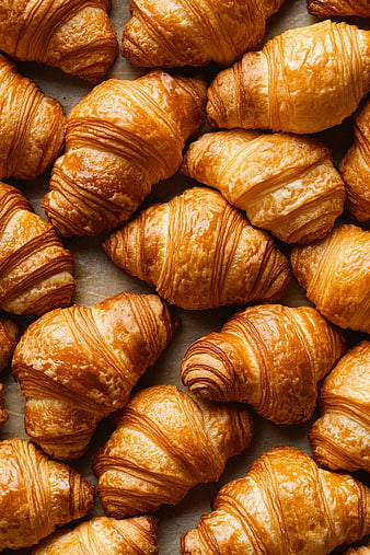 Fresh Golden Croissants on Baking Paper