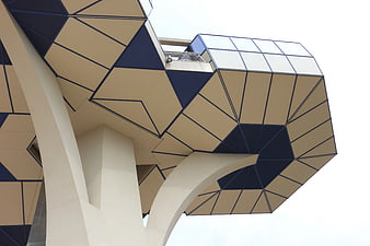 Low angle view of modern geometric beige and blue architecture