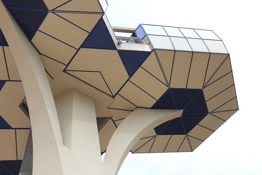 Low angle view of modern geometric beige and blue architecture