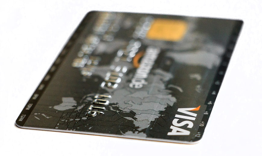 Black Visa Credit Card with World Map Design on White Background
