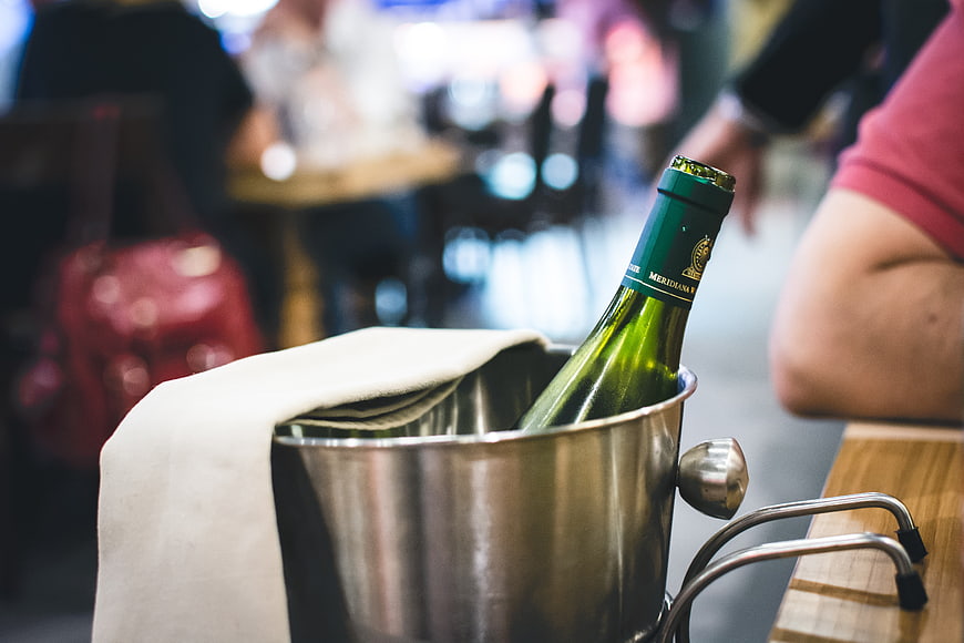Chilled Wine Bottle in Ice Bucket at Restaurant