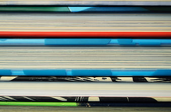 Close-up of stacked books with colorful spines and pages