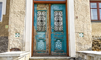 Weathered Blue Wooden Double Door With Ornate Iron Grilles