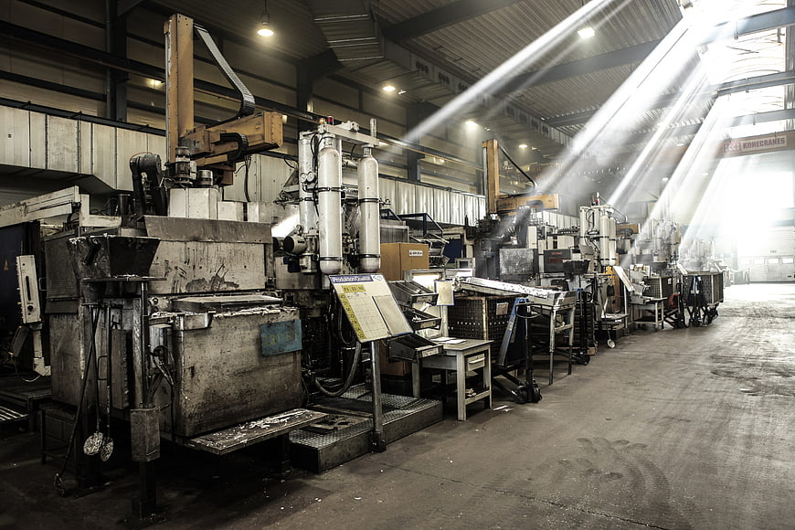 Industrial Factory Hall With Heavy Machinery And Dramatic Light Beams