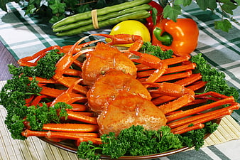 Steamed Snow Crab Legs with Fresh Vegetables on Plaid Tablecloth