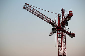 Red Construction Crane Against Clear Sky
