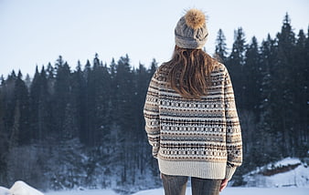 Woman in Knitwear Standing in Snowy Pine Forest