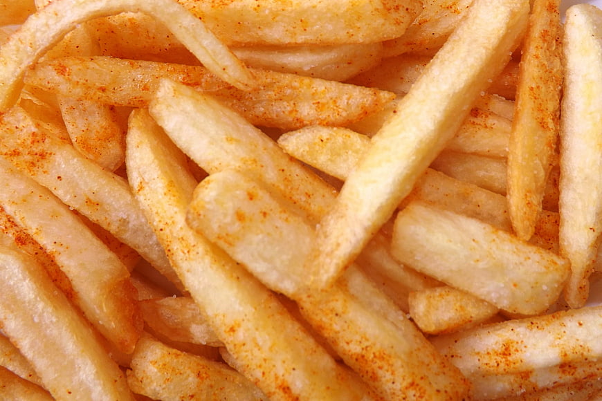 Close-up of seasoned french fries with spices