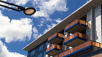 Modern Building Facade with Balconies and Street Lamp