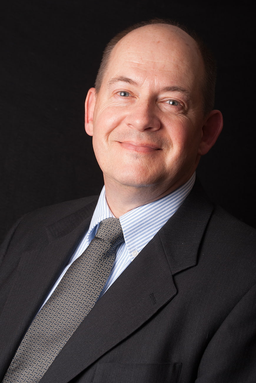 Professional Corporate Headshot of a Smiling Businessman in a Dark Suit