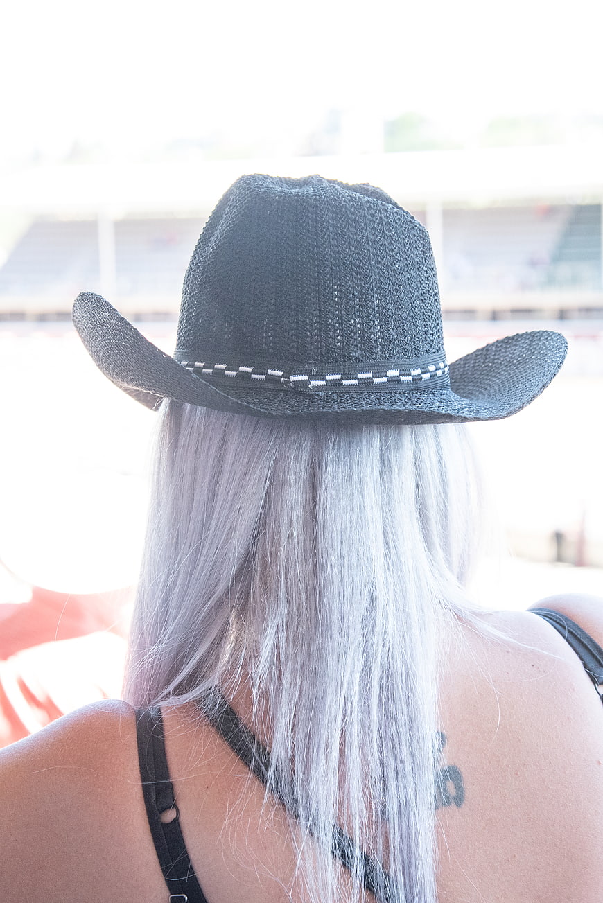 Back View of Woman with Silver Hair Wearing Black Cowboy Hat