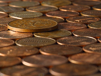 Close-up of scattered copper coins with shallow depth of field