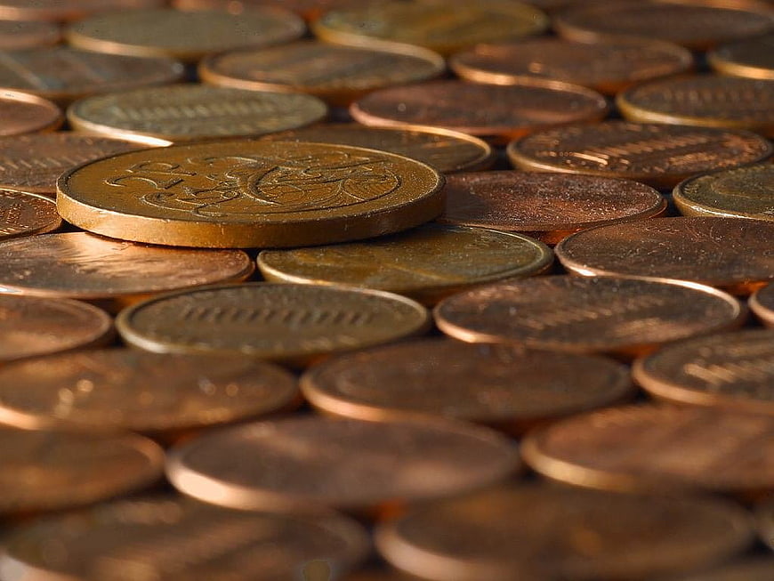 Close-up of scattered copper coins with shallow depth of field