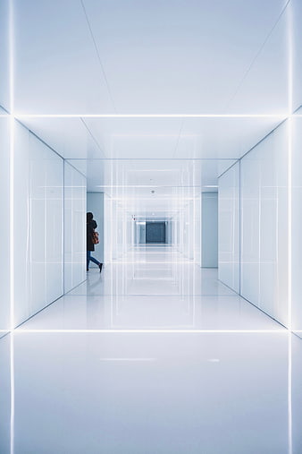 Futuristic white hallway with neon lights and lone figure