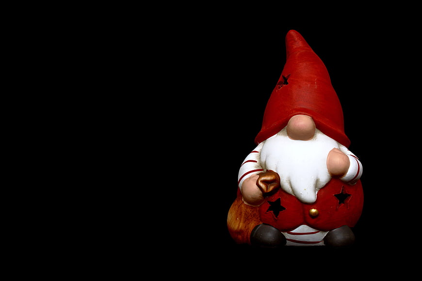 Christmas Gnome Figurine with Red Hat on Black Background