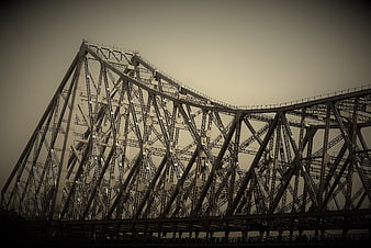Low angle view of steel truss bridge structure against sky