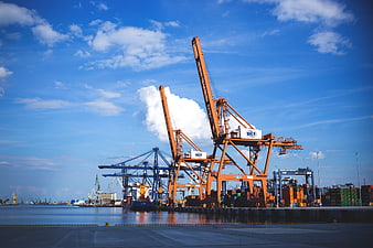Orange Port Cranes and Shipping Containers at Industrial Dock