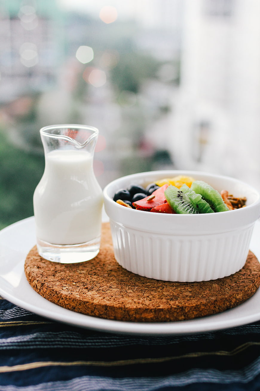 Healthy breakfast bowl with fresh fruit and milk