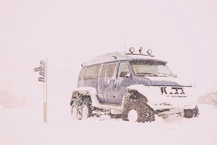 Blue 6x6 Expedition Vehicle in Heavy Snowstorm
