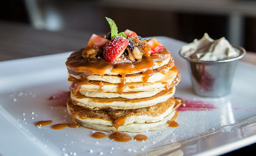 Stack of Gourmet Pancakes with Caramel Sauce and Strawberries