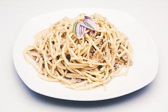 Creamy Spaghetti Carbonara on White Plate with Herb Garnish