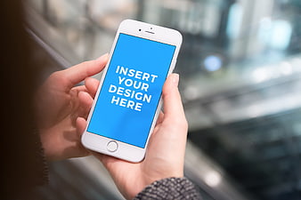 Woman holding smartphone with blue screen mockup