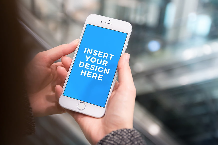 Woman holding smartphone with blue screen mockup
