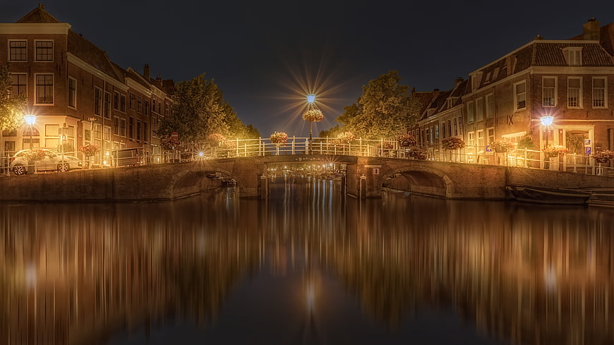 Night view of canal bridge with long exposure reflections