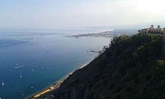Taormina Coastal Panorama With Sailboats And Cliffside Villa