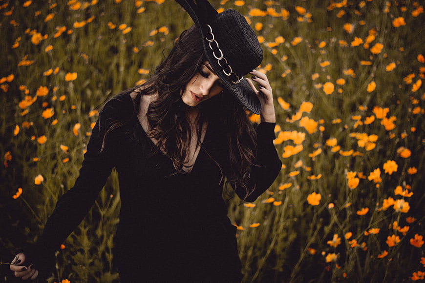 Woman in Black Hat in Orange Poppy Field