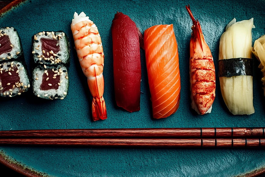 Assorted Sushi Platter with Chopsticks on Blue Plate
