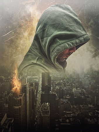 Hooded Man Silhouette Over Dark City Skyline With Fire And Smoke