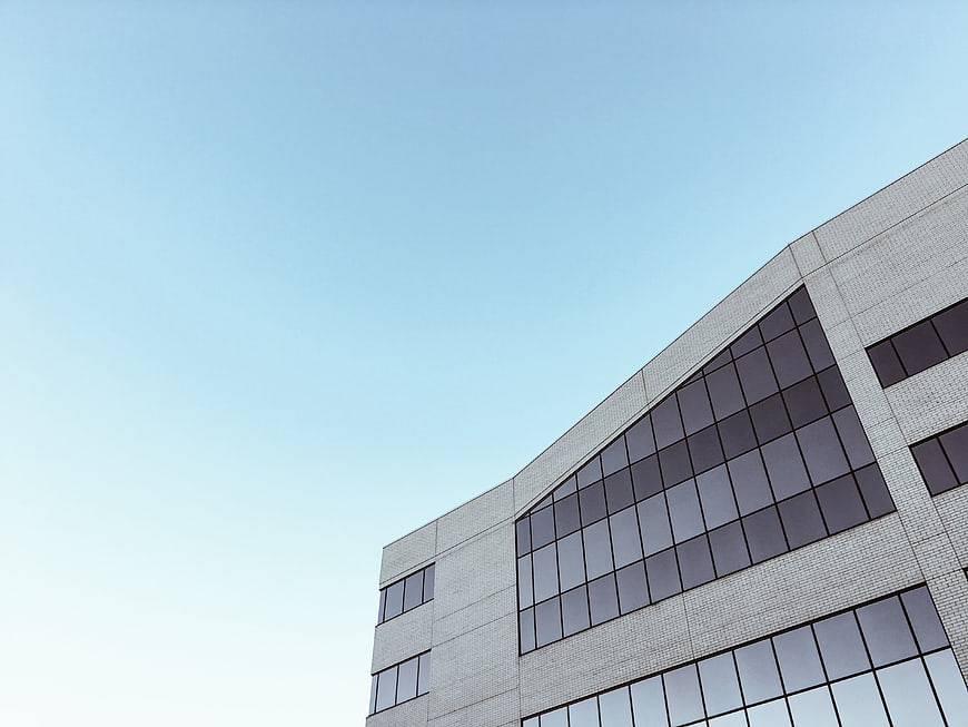 Modern Office Building Exterior with Blue Sky Background