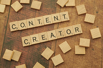 Content Creator spelled with wooden letter tiles on rustic background
