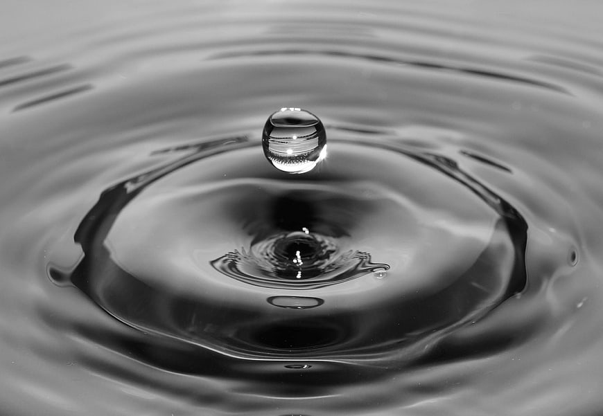 Black and white water droplet splash with ripples