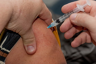 Close-up of medical injection into upper arm