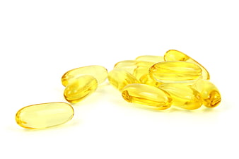 Yellow Omega-3 Fish Oil Capsules On White Background