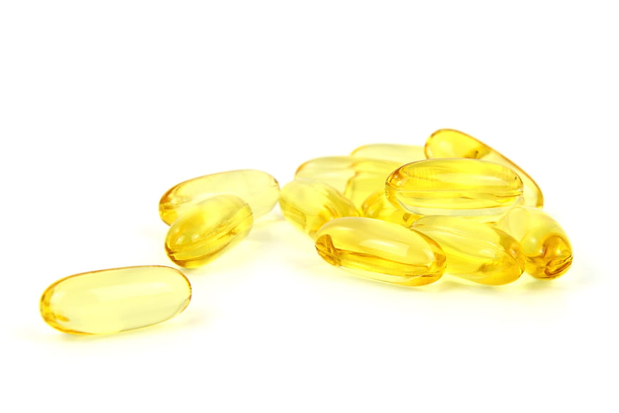Yellow Omega-3 Fish Oil Capsules On White Background