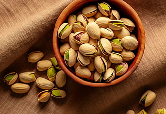 Top View of Shelled Pistachios in a Wooden Bowl