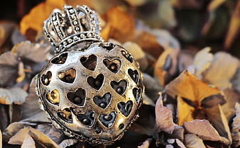Vintage silver heart locket on dried autumn leaves