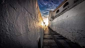 Narrow stone staircase in old town at sunset
